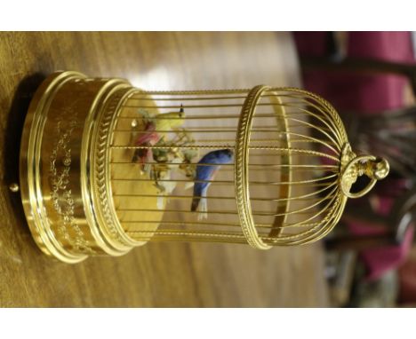 An attractive gilded brass Automaton Bird Cage, with domed top on circular base embossed with floral design, approx. 30cms (1