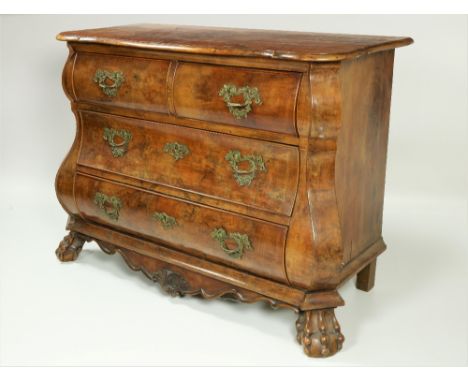 An 18th Century Dutch walnut bombe shaped Commode, the shaped figured top with moulded edge, over two short and two long draw