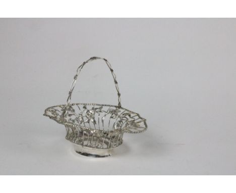 A George III Irish silver Sauceboat, by Matthew West, Dublin c. 1780, with bead punched border over embossed rural village sc