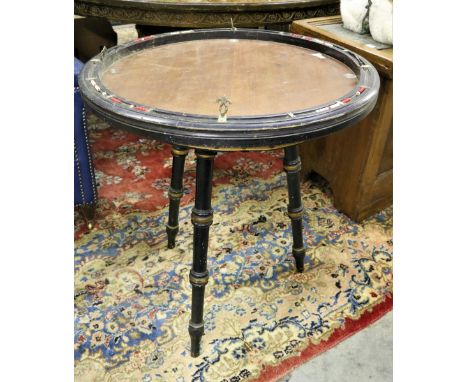 An unusual circular Games Table, with inset counters and counter holders on matching ebonised tripod base with turned taperin