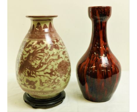 An early large Oriental bulbous ceramic Vase, decorated with prunus and other flowers, leaves and fish, in rusty pink colour 