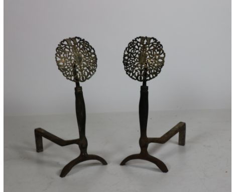 A good heavy pair of brass mounted cast iron Andirons, each with a pierced brass roundel finial, 25 1/2" (65cms). (2)