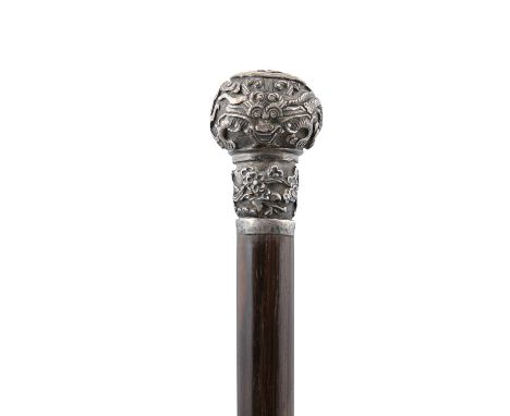 A SILVER HILTED ‘DRAGON’ WALK STICK VIETNAM, CIRCA 1900-1920 With a fluted wooden stick and a hilt or grasp of globular shape