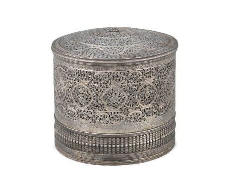 A LARGE RETICULATED AND CHISELED SILVER BETHEL BOX AND COVER  BURMA (MYANMAR), 19TH CENTURY Of circular shape, topped by a do