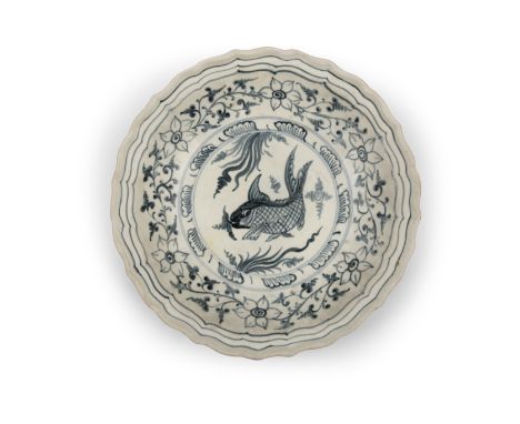 *A BLUE AND WHITE PORCELAIN ‘FISH’ SCALLOPED SHALLOW DISH VIETNAM, LÊ DYNASTY, 15TH OR 16TH CENTURY A shallow dish of circula