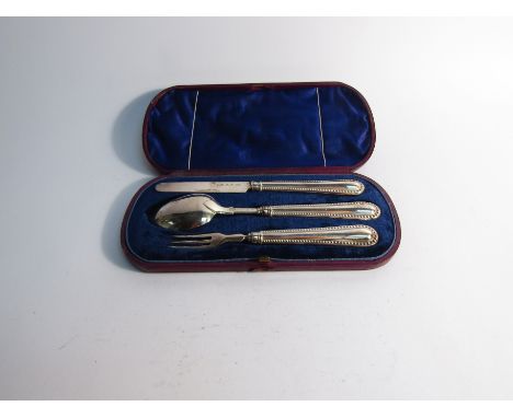 A George Unite silver three piece christening set, spoon, fork and knife with beaded edge, Birmingham 1869