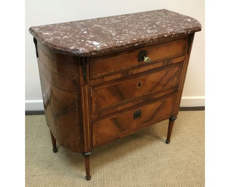 A 19th Century French walnut commode, the rosso marble top with curved ends over three parquetry banded graduated drawers rai