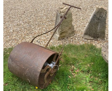 A 19th Century wrought iron garden roller, together with two natural stone staddle stone bases 