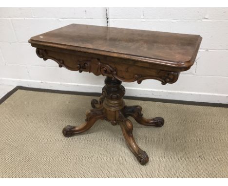 A Victorian walnut fold-over card table on centre pedestal to quadruped base and scroll feet, 92 cm wide x 72 cm high