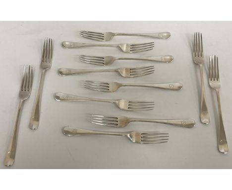 A set of twelve George VI silver "Old English" pattern dessert forks and a matching set of twelve table forks, each with styl