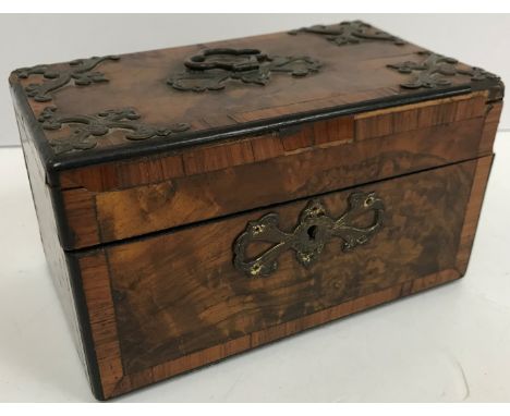 A Victorian Gothic Revival burr walnut and cross banded tea caddy of plain rectangular form, the top with brassed embellishme