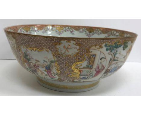 A Chinese Kangxi punch bowl, the inner field decorated with fruit and flowers, the outside decorated with panels of figures i