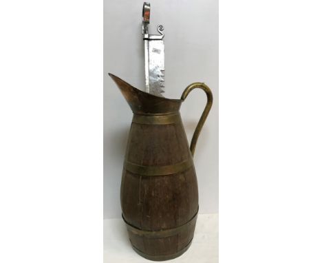 A large brass bound coopered oak jug or stick stand of bellied form 69 cm high together with a polished steel fire crane 98 c