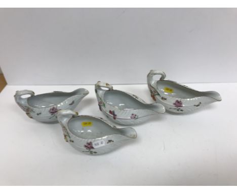 A composite set of four Chelsea style cabbage leaf moulded sauceboats decorated with floral sprays and butterflies and other 