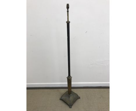 An early 20th Century painted iron and brass adjustable standard lamp in the Regency style, the base with harebell decoration