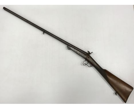 A 19th Century pinfire breach loading hammer action shotgun, double 29.5" barrels, side by side, with engraved metal work and