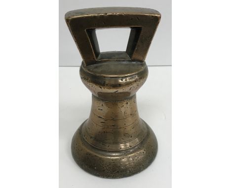 A large 19th Century bell metal bell weight (approx 28lbs), a circa 1900 Contintental pin work decorated watch stand as a lon