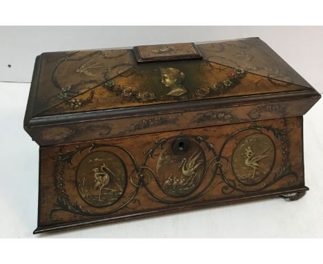 A 19th Century birds eye maple sarcophagus shaped tea caddy, the quartered lid painted with figural busts and swallows amongs