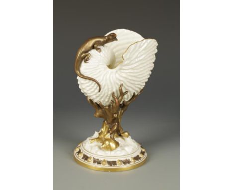 A ROYAL WORCESTER PORCELAIN VASE in the form of a nautilus shell with applied lizard on naturalistic base applied with shells