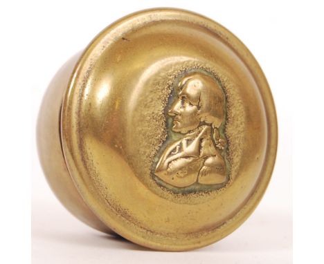 An antique likely 19th century circular brass snuff / trinket box dedicated to Admiral Lord Nelson with stamped bust to top. 