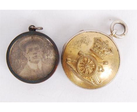Two WWI First World War period sweetheart lockets. The first being hallmarked silver Royal Artillery badge for a lock of hair