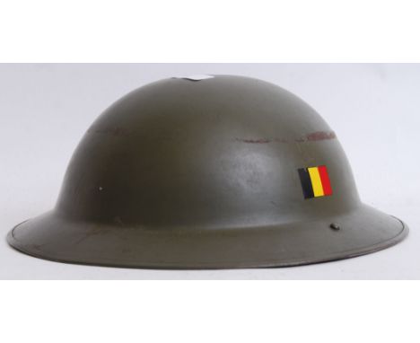 An original Second World War WWII green tin helmet with German flag to side. With original liner.  POSTAGE: Worldwide postage