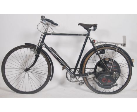 An early 1950's (1950-1952) Raleigh Cyclemaster 25cc aircooled engine powered bicycle. In black, with dynamo lights and lugga