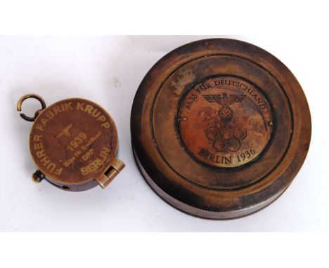 Two vintage style 20th century German Compasses. The first being a ' Berlin 1936 ' compass and the other being a compass stam