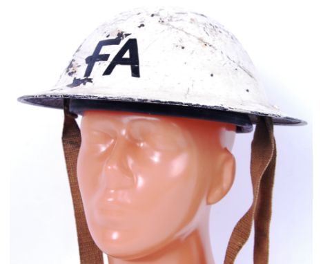 An original WWII Second World War white First Aid uniform helmet. 'F A' painted to front and back. Stamp to rim (unreadable).