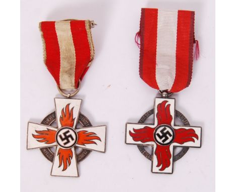 Two Third Reich Nazi German made enamel Fireman's badges. One original, the other possibly a reproduction. Both decorated wit