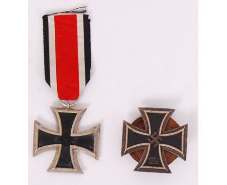 Two original German Iron Cross medals. EK1 First Class and EK2. First class with screw back and the other with original ribbo