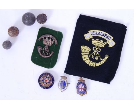 A collection of assorted naval and military items. Comprising of: 4x antique musket balls, a Jellalabad silver pouch brooch, 