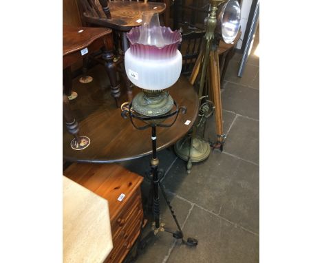 A floor standing parafin lamp with wrought metal stand, height 135cm. 