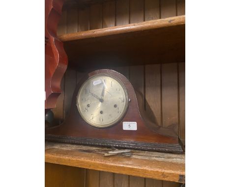 A mantel clock with key. 