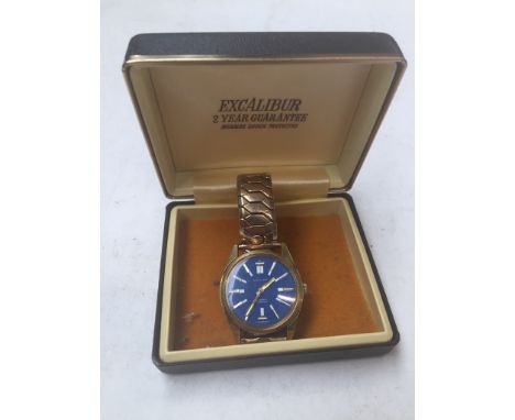 A vintage gold plated Excalibur 17 jewel manual wind wristwatch with signed blue dial, stainless steel screw back and on gold