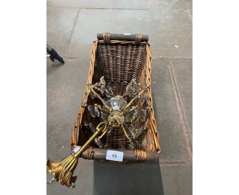 A gilt metal light fitting with glass droplets and a basket. 