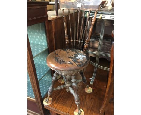 A late 19th century/ early 20th century spindle back chair with adjustable seat and glass ball and claw feet, height 90cm, wi