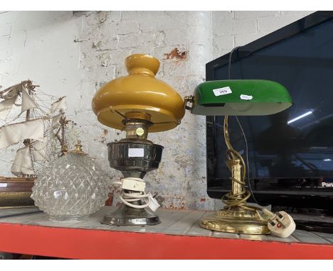 A brass and green glass reading lamp, a paraffin lamp converted to electric with mustard glass shade and pair of cut glass li