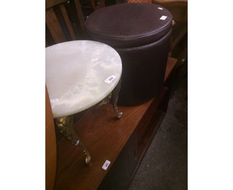 An onyx and brass coffee table and a pouffe/ stool. 