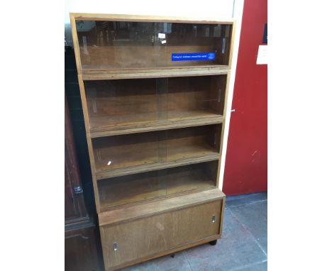 A sectional cabinet bookcase with sliding glass doors, height 167cm, width 91.5cm, depth 33cm. 