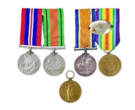 A WWI pair to Gnr R Bray RA. Britsh War and Victory medals, the ribbons with attached dog tag, together with a Victory medal 