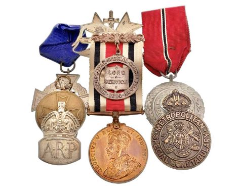 Four German war medals WWII Merit cross, Third Reich Faithful Service silvered cross, WWII bronze war Merit medal, and 1938 S