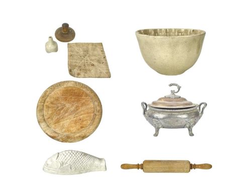 A collection of kitchenalia.  Comprising a treen butter stamp carved with a sheep, 9.5cm diameter, a breadboard carved with t