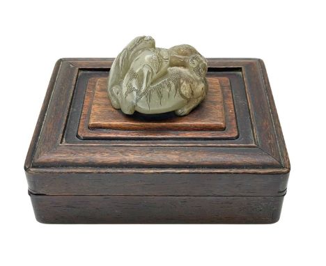 A Chinese carved jade group of two entwined lion dogs. Qing, well detailed and with incised decoration, now drilled and mount