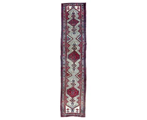 A Sarab runner, North West Persia, circa 1930-1950. The camel field with three madder serrated pole medallions, within three 