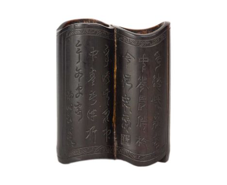 A Chinese twin section bamboo brush pot, 19th century. The front carved with pagoda, bridge and trees, with calligraphy to th