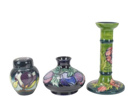 A Moorcroft 'Anemone' candlestick. Date stamped for 1991, height 20.5cm, with a small ginger jar in the 'Wine Magnolia' patte