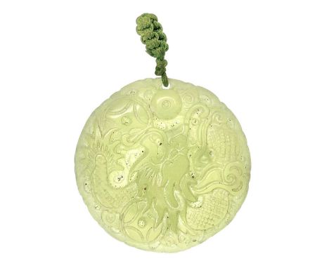 A Chinese jade circular pendant. 20th century, carved with a phoenix and a dragon, diameter 4.3cm.