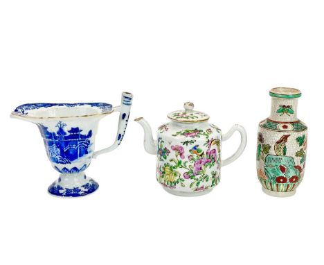 A Chinese porcelain famille rose small teapot. Circa 1900, height 8.5cm, together with a Qianlong export blue and white sauce