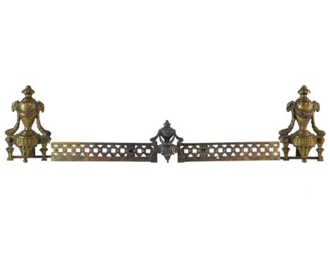 A pair of French brass Chenets and fender rail. With ram's mask mounted urn finials, with a further urn centering the rail, h